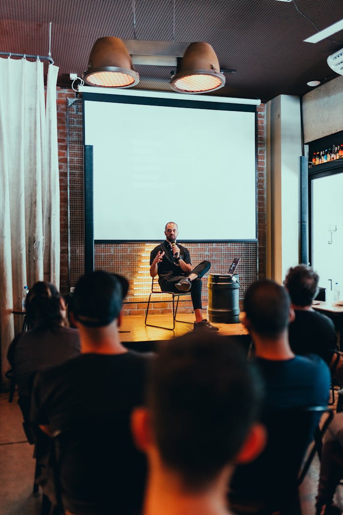 Speaker engages an audience during a business seminar in a modern conference room.