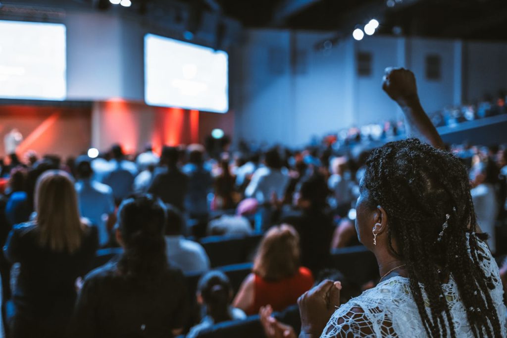 Vibrant crowd at a conference with a focus on an attentive participant.